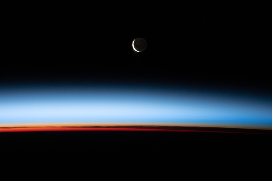 A waxing crescent moon is photographed from the International Space Station during an orbital sunset as the ISS flies above the Pacific. Image publishes December 27, 2021 by NASA.