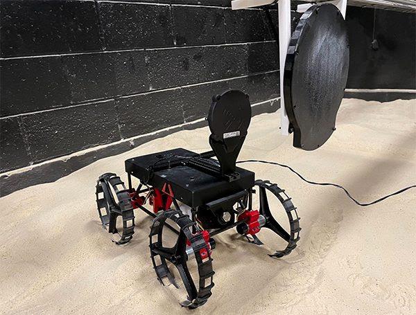 A 3D printed mini rover being charged by Astrobotic's wireless system