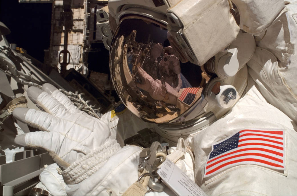 Via NASA: "Astronauts Jim Reilly and John Olivas (visible among Reilly's helmet reflections), both STS-117 mission specialists, participate in the mission's first planned session of extravehicular activity, resuming construction on the ISS. Among other tasks, Reilly and Olivas connected power, data and cooling cables between S1 and S3."