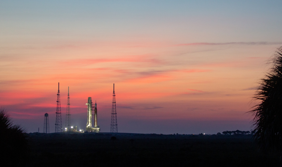 NASA’s Space Launch System (SLS) rocket with the Orion spacecraft aboard is seen at sunrise atop the mobile launcher as it arrives at Launch Pad 39B, Wednesday, Aug. 17, 2022.