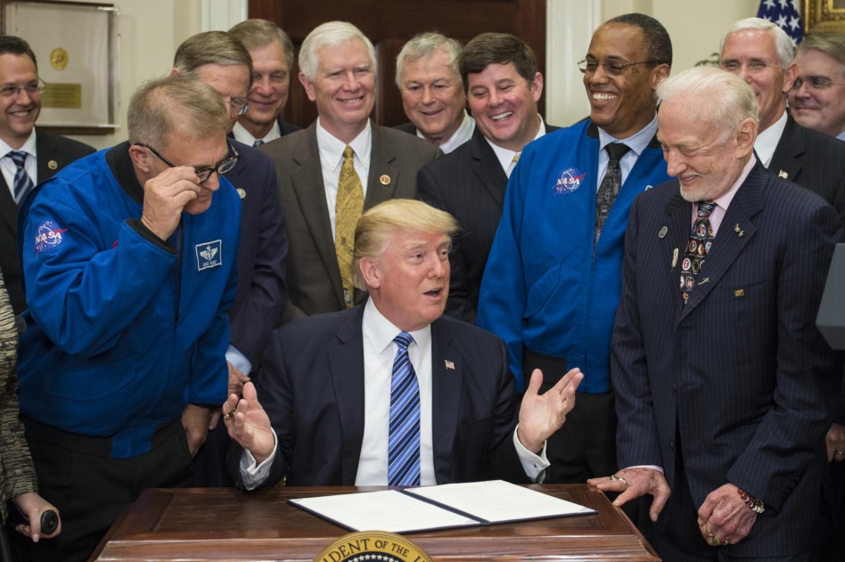 President Donald Trump, center, speaks to the crowd before signing an Executive Order to reestablish the National Space Council, alongside members of the Congress, National Aeronautics and Space Administration, and Commercial Space Companies in the Roosevelt room of the White House in Washington, Friday, June 30, 2017.